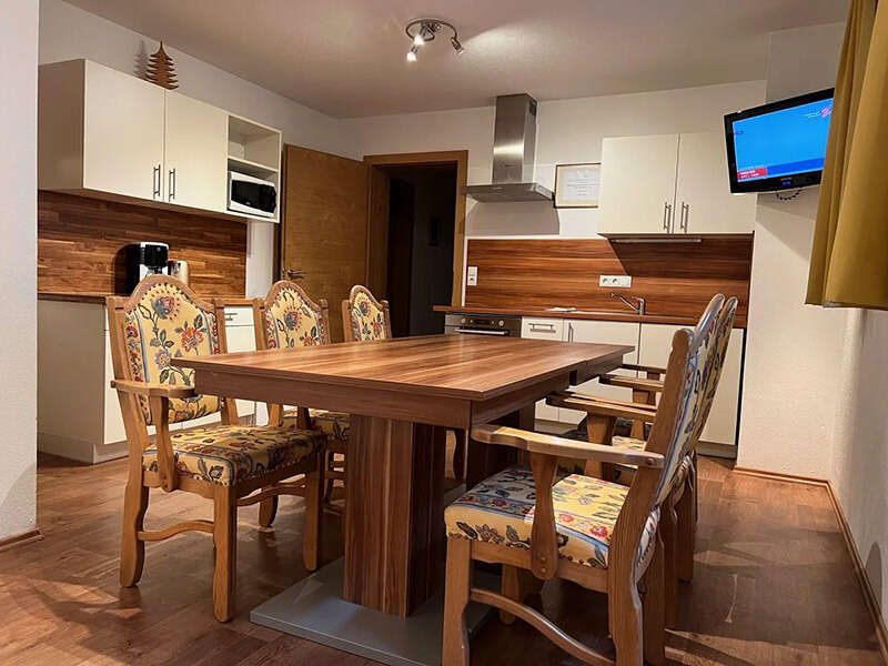  Guest kitchen with dining table and chairs and TV